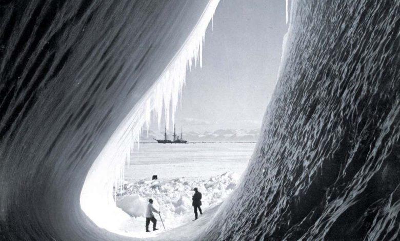 Grotto in a berg, Terra Nova in distance Taylor and Wright (interior), Antarctica, 5th January 1911. British Antarctic Expedition 1910-1913. (Photo by Herbert Ponting/Royal Geographical Society via Getty Images)