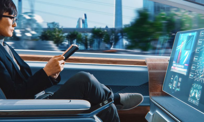 passenger reading a book in an autonomous self-driving car
