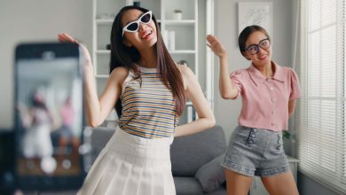 Asian young woman with her friend tiktoker created her dancing video by smartphone camera together. To share video on social media application; Shutterstock ID 2159904237; purchase_order: -; job: -; client: -; other: -
